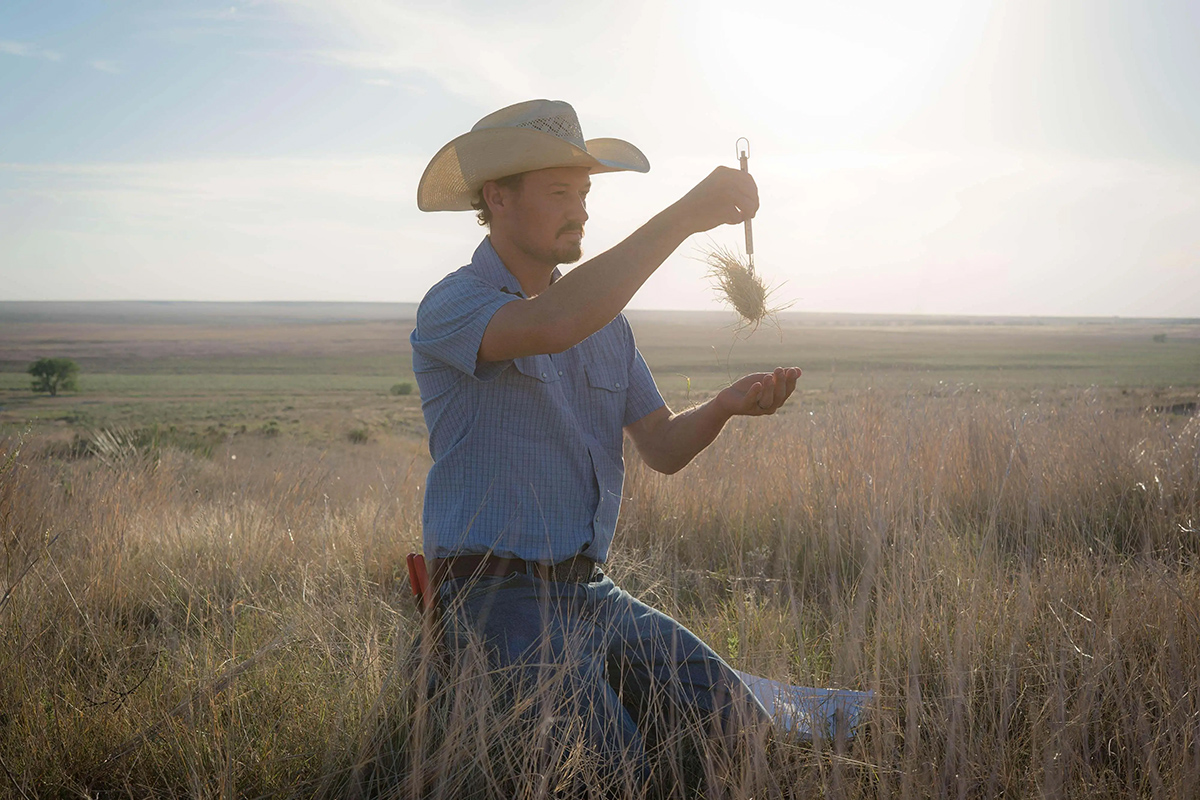 Smoky Valley Ranch manager Justin Roemer monitors a plant on the prairie. © Morgan Heim